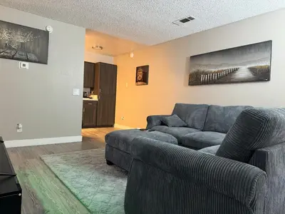 a living room with a blue couch and a table at The Chic Loft in Riverside
