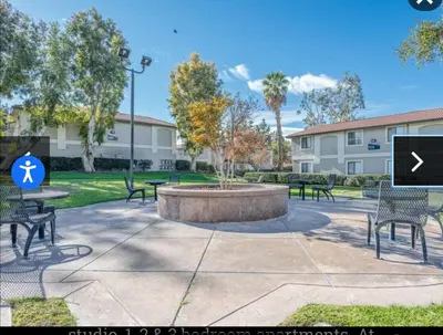 a park with benches and a fountain with a sign at The Chic Loft in Riverside