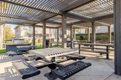 a picnic table and benches under a pavilion at The Chic Loft in Riverside
