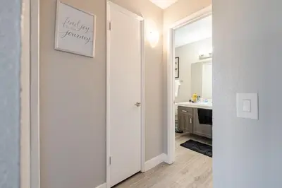 a white bathroom with a sink and a mirror at The Chic Loft in Riverside