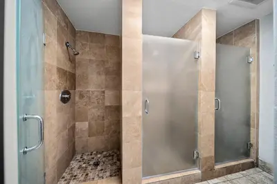 a shower with a glass door in a bathroom at Samesun Hollywood Hotel & Hostel in Los Angeles