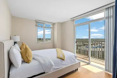 a white bedroom with a bed and a large window at The Bleu Pearl 3Bed 2bath Venice Beach Santa Monica and Marina Del Rey in Los Angeles