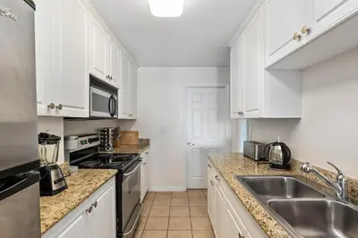a kitchen with white cabinets and a sink at The Bleu Pearl 3Bed 2bath Venice Beach Santa Monica and Marina Del Rey in Los Angeles