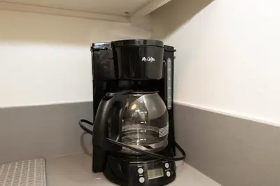 a black coffee maker sitting on a counter at Hollywood Luxe 2BR Apartment with Rooftop Pool and Breathtaking Views in Los Angeles