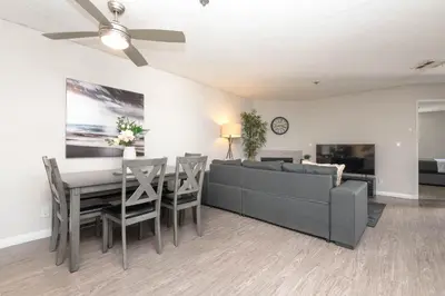 a living room with a couch and a table at Hollywood Luxe 2BR Apartment with Rooftop Pool and Breathtaking Views in Los Angeles