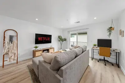 a living room with a couch and a desk at South Bay 3 bed Escape! in Harbor City