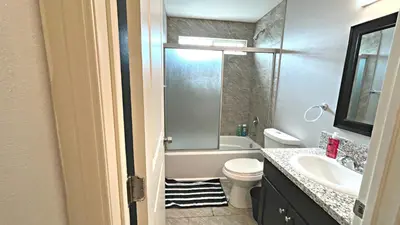 a bathroom with a toilet and a tub and a sink at The Blue Hostel - Near USC, BMO in Los Angeles