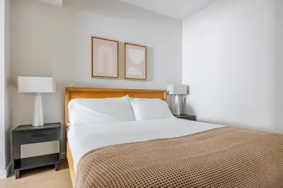 a bedroom with a bed and two pictures on the wall at Blueground Downtown elevator nr parks LAX-1247 in Los Angeles