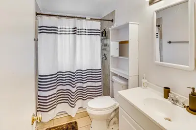 a bathroom with a shower and a toilet and a sink at Work, Play and Relax Home with Yard in Lancaster! in Lancaster