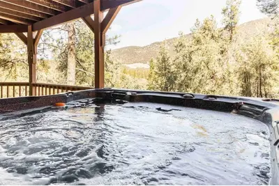 a hot tub on the porch of a house at ADELAIDE HILL IN PINE MOUNTAIN CLUB BREATHTAKING VIEWS 3Bd 3Bth SPA TUB in Pine Mountain Club
