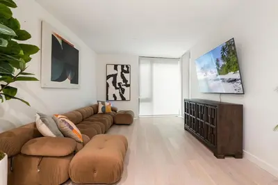 a living room with a couch and a flat screen tv at Luxurious 2-Bedroom Retreat in Santa Monica in Los Angeles