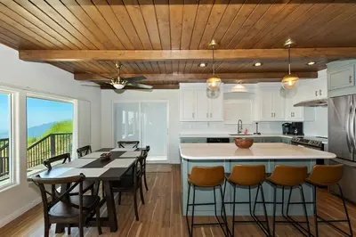 a kitchen with a table and chairs and a counter top at Lake Gregory Skyline Ridge in Crestline
