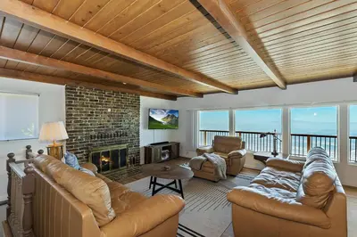 a living room with leather furniture and a fireplace at Lake Gregory Skyline Ridge in Crestline