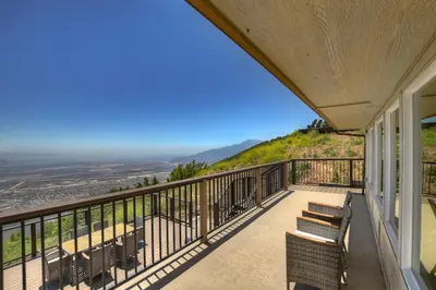 a balcony of a house with benches on it at Lake Gregory Skyline Ridge in Crestline