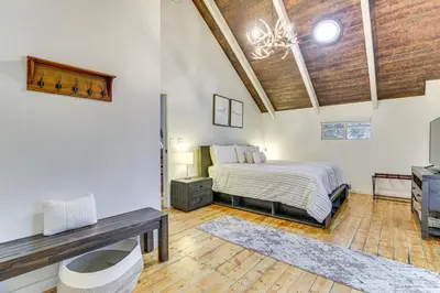 a bedroom with a bed and a wooden ceiling at Family-Friendly Lake Arrowhead Cabin with Game Room! in Lake Arrowhead