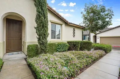 a house with a door and some bushes and flowers at Gorgeous Family Home, Close to Frwys, Hospitals & Sports Arenas, Pets OK in Orange