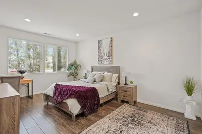 a bedroom with a king sized bed and a desk at Gorgeous Family Home, Close to Frwys, Hospitals & Sports Arenas, Pets OK in Orange