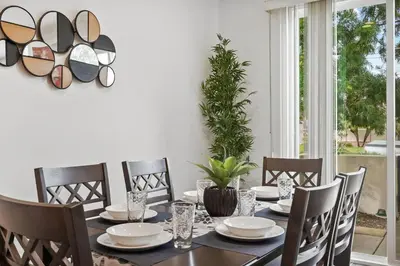 a dining room with a table and chairs at Gorgeous Family Home, Close to Frwys, Hospitals & Sports Arenas, Pets OK in Orange