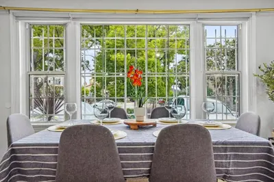 a dining room with a table and chairs and a large window at Foosball l LA Mural l DTLA l UnivStudios l BevHills in Glendale