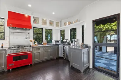 a large kitchen with a red stove top oven at Casa Cortona by Stay Awhile Villas in Los Angeles