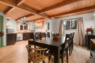 a kitchen with a dining room table and chairs at Midnight Pines Cabin - Cozy Get-Away Near Slopes! in Big Bear Lake