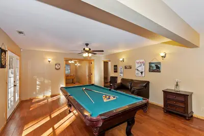 a pool table in a living room with a ceiling at Big 10 Luxury Cabin/Walk to Snow Summit- HotTub in Big Bear Lake