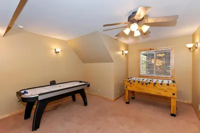 a room with a ping pong table and a ceiling fan at Big 10 Luxury Cabin/Walk to Snow Summit- HotTub in Big Bear Lake