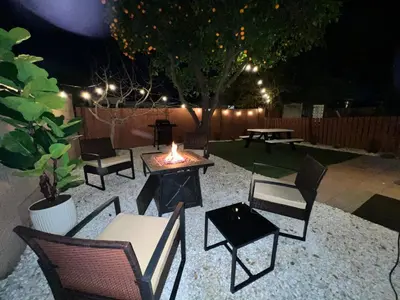 a backyard with chairs and a fire pit at night at Mini-Home in Whittier in Whittier