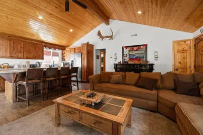 a living room with a couch and a table at Lakeside Cottage, Charming 3-BDRM Retreat W Hottub in Big Bear Lake