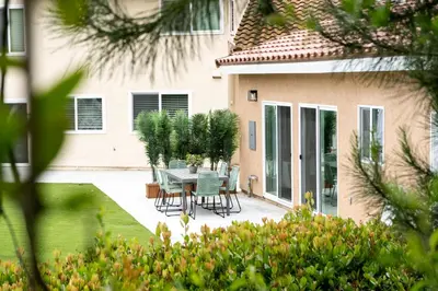 a patio with a table and chairs in front of a house at Newly built vacation home with large backyard in Diamond Bar