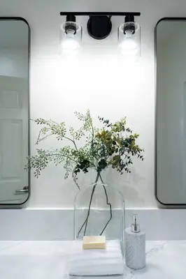 a vase with flowers in it on a bathroom counter at Newly built vacation home with large backyard in Diamond Bar