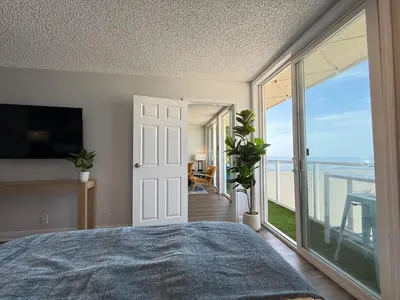 a bedroom with a bed and a view of the ocean at Oceanfront Sanctuary 1 BR Beach Access 218 in Hermosa Beach