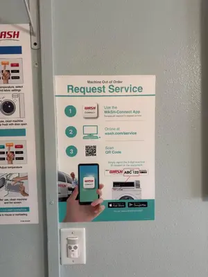 a request service sign on a wall with a person holding a cell phone at Oceanfront Sanctuary 1 BR Beach Access 218 in Hermosa Beach