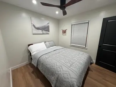 a bedroom with a bed and a ceiling fan at Modern Bedroom in Long Beach 1 in Long Beach