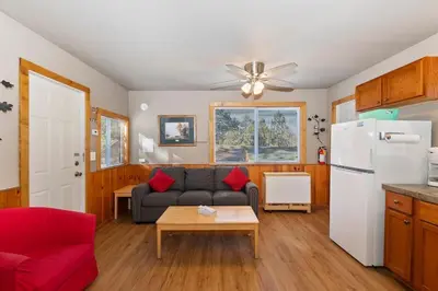 a living room with a couch and a refrigerator at Rosy Cozy Cottage-Walk to Big Bear Lake in Big Bear Lake