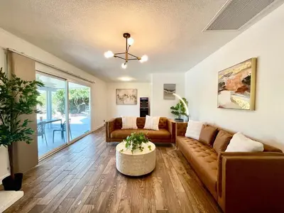 a living room with a couch and a table at Unique & Spacious house near Disney, Knott, BBQ in Buena Park
