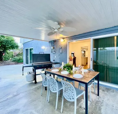 a dining room with a table and a piano at Unique & Spacious house near Disney, Knott, BBQ in Buena Park