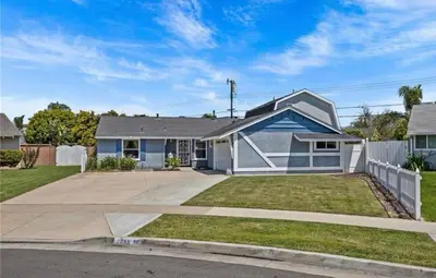 a white and blue house with a fence at Unique & Spacious house near Disney, Knott, BBQ in Buena Park