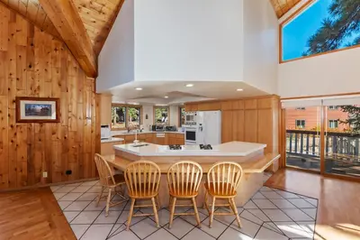 a kitchen with wooden walls and a table with chairs at Lakefront Estate with Views and Hot tub in Big Bear Lake