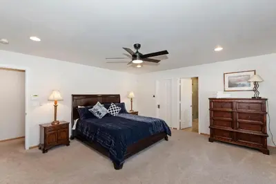 a bedroom with a bed and a ceiling fan at Lakefront Estate with Views and Hot tub in Big Bear Lake