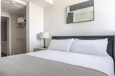 a white bed with white pillows in a bedroom at Blueground Downtown elevator nr parks LAX-1250 in Los Angeles