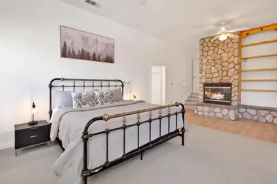 a bedroom with a bed and a fireplace at Castlewood Retreat at Big Bear Central Modern Family Chalet in Big Bear Lake