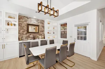 a dining room with a white table and chairs at Castlewood Retreat at Big Bear Central Modern Family Chalet in Big Bear Lake