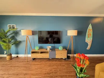 a living room with two lamps and a surfboard on the wall at Oceanfront 1 Bed 1 Bath , Parking, Stunning View 337 in Redondo Beach