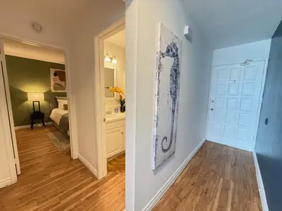 two images of a hallway with a bedroom and a door at Oceanfront 1 Bed 1 Bath, Parking, Amazing View 132 in Redondo Beach