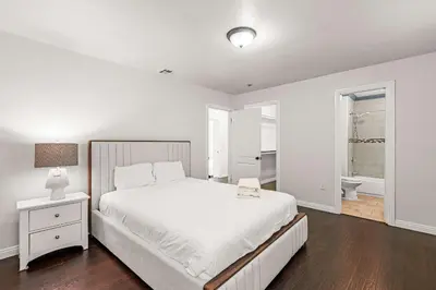 a white bedroom with a large bed and a window at Spacious Retreat w Large Kitchen & Outdoor Patio in Pasadena