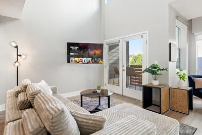 a living room with a couch and a table at Spacious Loft- Hollywood Free Pool, Parking, Gym in Los Angeles