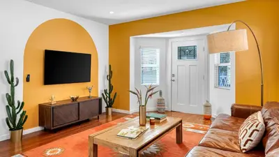 a living room with a couch and a tv at 2 Units in Prime Hollywood Location Chic Renovated 1BDRs w Patio AvantStay in Los Angeles