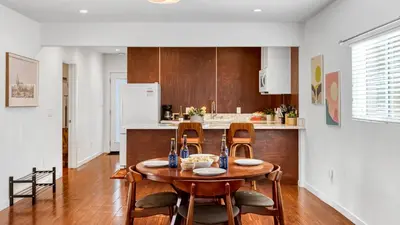 a kitchen with a wooden table and chairs in a room at 2 Units in Prime Hollywood Location Chic Renovated 1BDRs w Patio AvantStay in Los Angeles