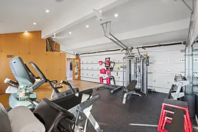 a gym with several treadmills and cardio machines at The Surf Lodge Villa in Malibu